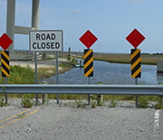 Closed highway that abruptly ends in open water.